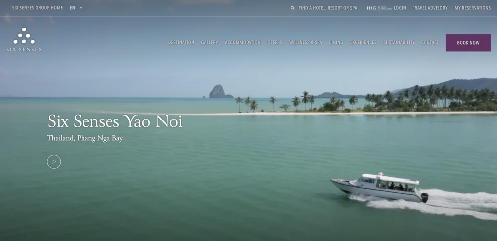 A speedboat glides through turquoise waters near a tropical island, framed by palm trees and a distant rock formation. The text reads, "Six Senses Yao Noi, Thailand, Phang Nga Bay," offering the best hotel website design for a seamless luxury experience.